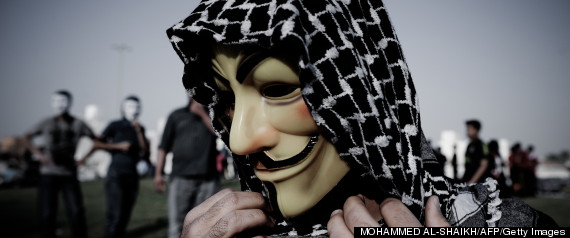 A Bahraini protester wearing a Guy Fawkes mask used by the Anonymous movement takes part in a demonstration against the government and in solidarity with jailed freelance photographer Ahmed Humaidan in the village of Karranah, west of Manama, on March 1, 2013. Humaidan was arrested during a rally on December 29, 2012 and was charged with "demonstrating illegally" and "using violence to assault police and damage public properties".